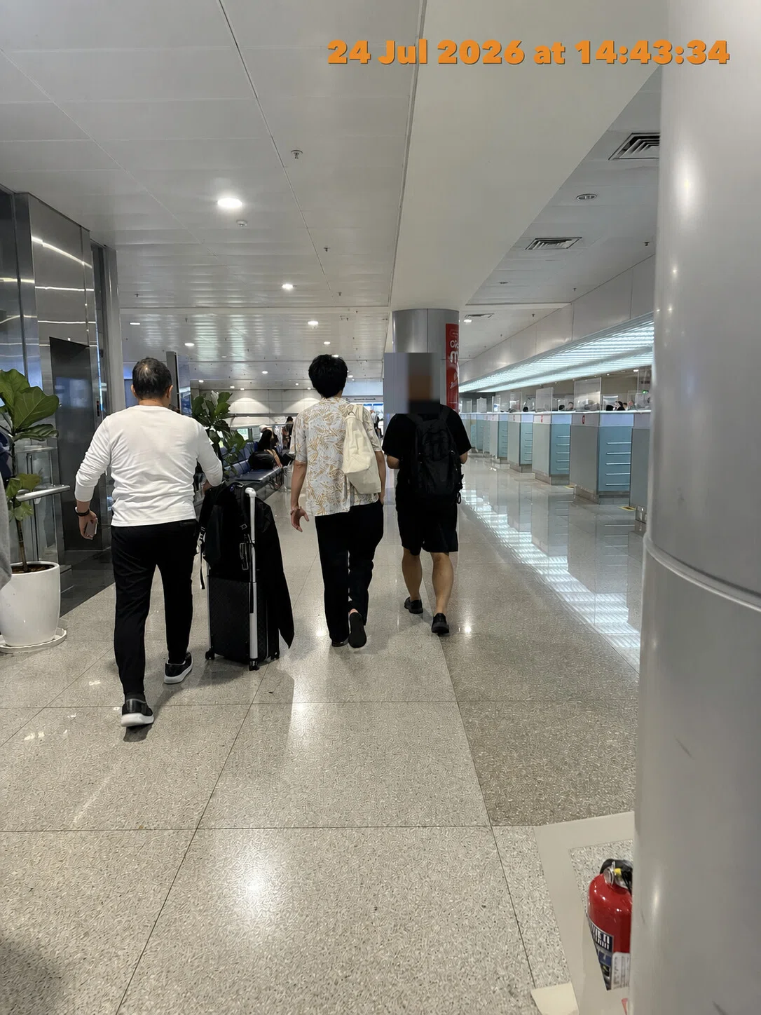 VN321 passenger moving through Tan Son Nhat International Airport after completing immigration